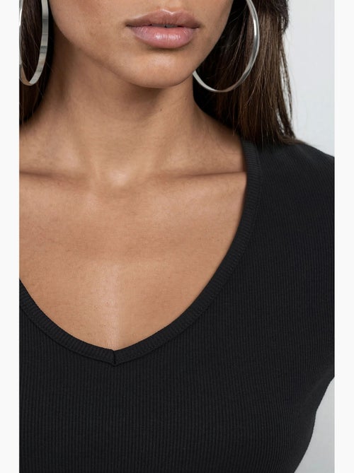 Blusa a coste con scollo a v busem - Kiabi Blusa a coste con scollo a v busem - Kiabi