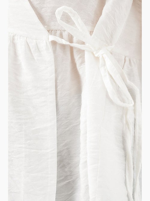 Blusa a portafoglio in crepe con scollo a v e dettaglio fiocco bdart - Kiabi Blusa a portafoglio in crepe con scollo a v e dettaglio fiocco bdart - Kiabi