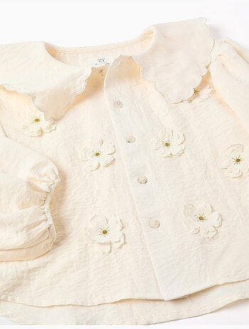 Blusa con maniche a palloncino e applicazione floreale