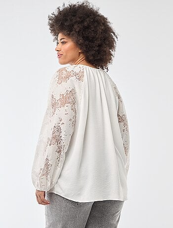 Blusa con maniche lunghe in pizzo e apertura con laccetti al collo