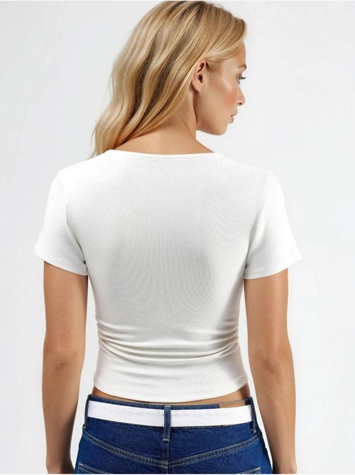 Blusa in maglia elasticizzata aderente con dettaglio drappeggiato hiccup - Kiabi Blusa in maglia elasticizzata aderente con dettaglio drappeggiato hiccup - Kiabi