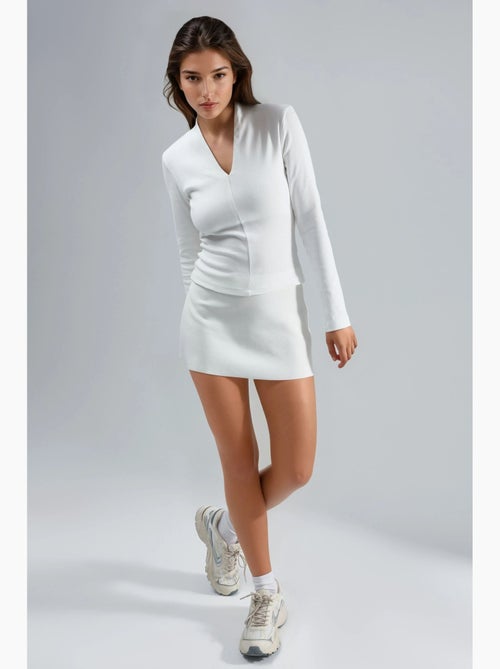 Blusa slim fit a maniche lunghe con scollo a v busem - Kiabi Blusa slim fit a maniche lunghe con scollo a v busem - Kiabi
