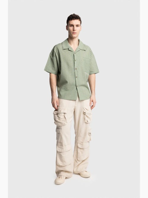 Camicia a maniche corte a righe testurizzate con taschino giesto - Kiabi Camicia a maniche corte a righe testurizzate con taschino giesto - Kiabi