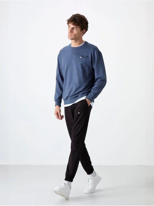 Completo felpa e pantaloni oversize girocollo tommy - Kiabi Completo felpa e pantaloni oversize girocollo tommy - Kiabi
