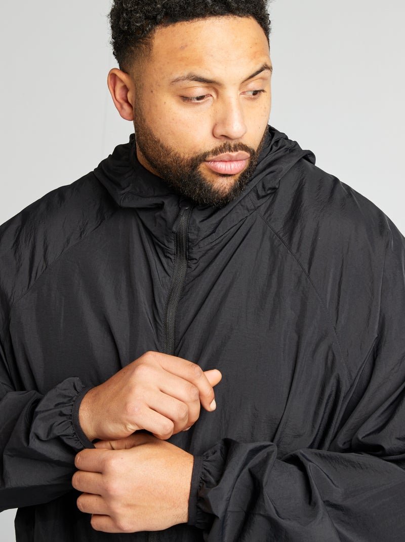 Giacca a vento tinta unita ripiegabile nel cappuccio nero - Kiabi