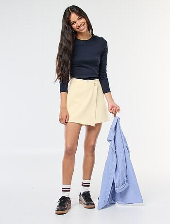 Gonna pantalone asimmetrica con bottone dorato