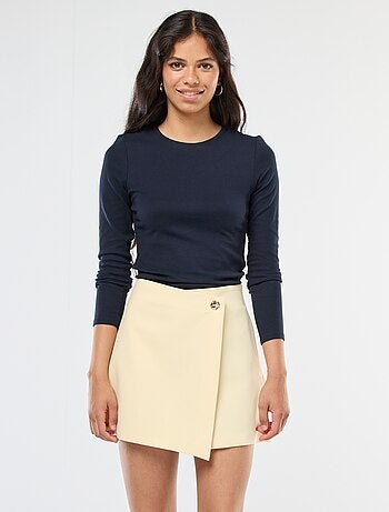 Gonna pantalone asimmetrica con bottone dorato