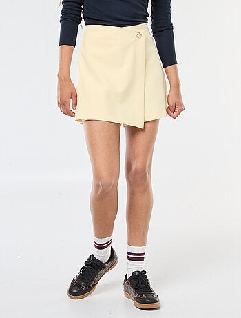 Gonna pantalone asimmetrica con bottone dorato