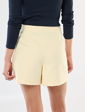 Gonna pantalone asimmetrica con bottone dorato