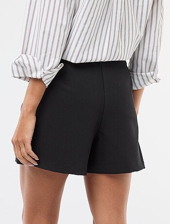 Gonna pantalone asimmetrica con bottone dorato