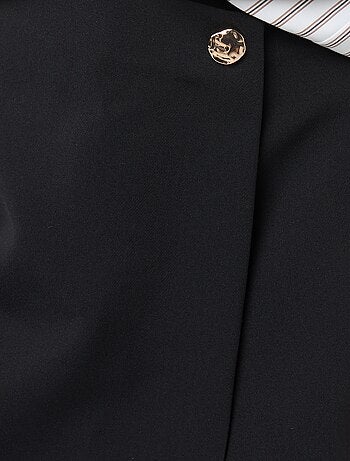 Gonna pantalone asimmetrica con bottone dorato