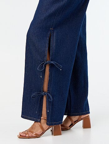 Jeans wide leg con nodi fantasia sui lati