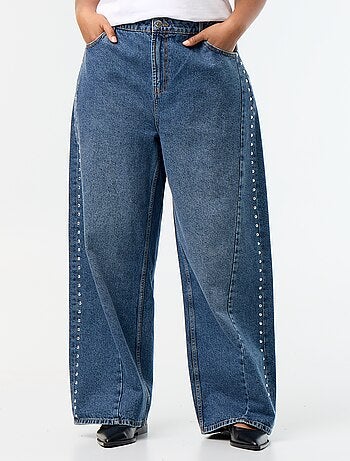 Jeans wide leg con tagli fantasia e borchie