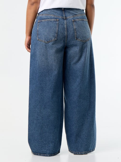 Jeans wide leg con tagli fantasia e borchie - Kiabi Jeans wide leg con tagli fantasia e borchie - Kiabi