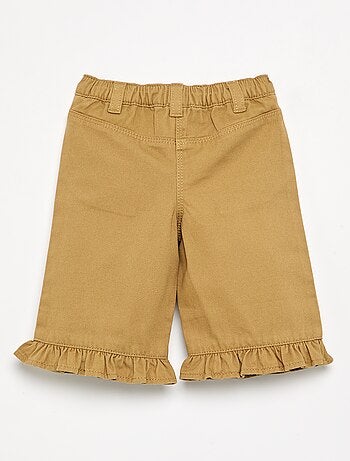 Pantalone a tinta unita con fondo a balze