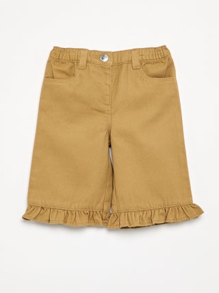 Pantalone a tinta unita con fondo a balze