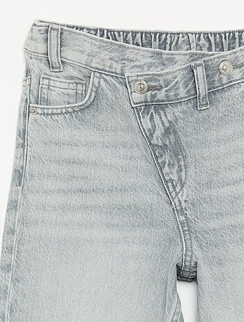 Pantalone in denim con abbottonatura asimmetrica