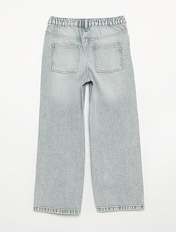Pantalone in denim con abbottonatura asimmetrica