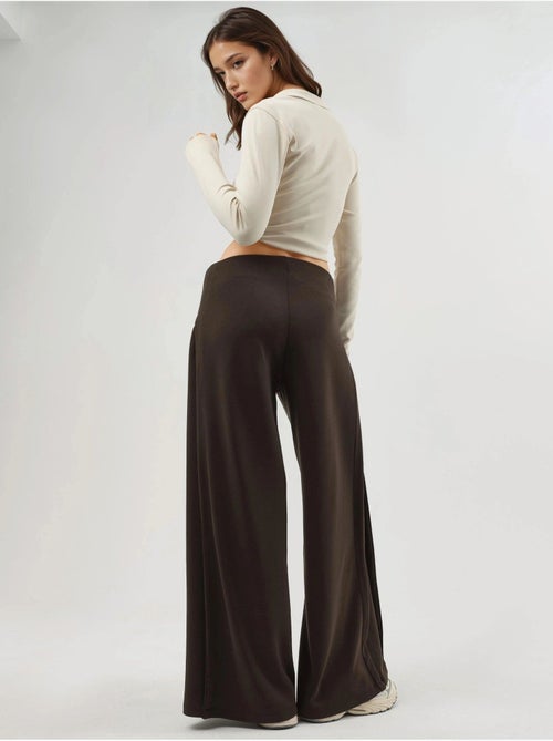 Pantaloni a gamba ampia con pieghe busem - Kiabi Pantaloni a gamba ampia con pieghe busem - Kiabi