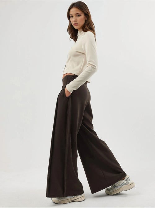 Pantaloni a gamba ampia con pieghe busem - Kiabi Pantaloni a gamba ampia con pieghe busem - Kiabi