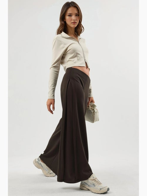 Pantaloni a gamba ampia con pieghe busem - Kiabi Pantaloni a gamba ampia con pieghe busem - Kiabi