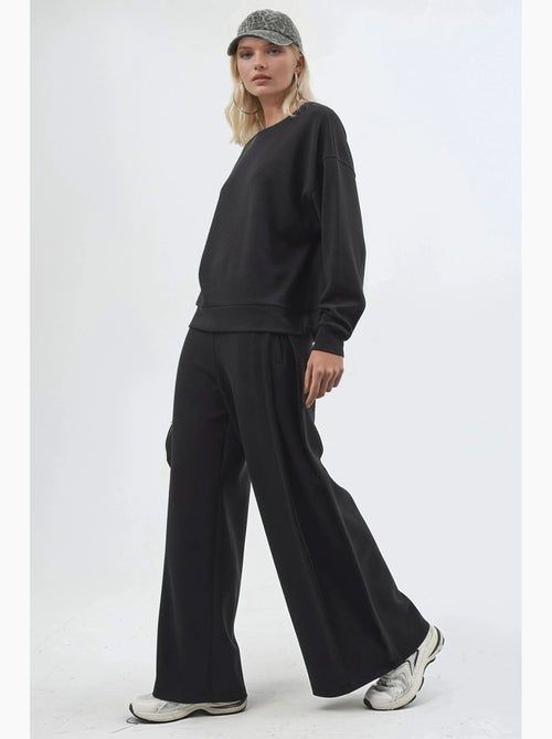Pantaloni a gamba ampia con pieghe busem - Kiabi Pantaloni a gamba ampia con pieghe busem - Kiabi
