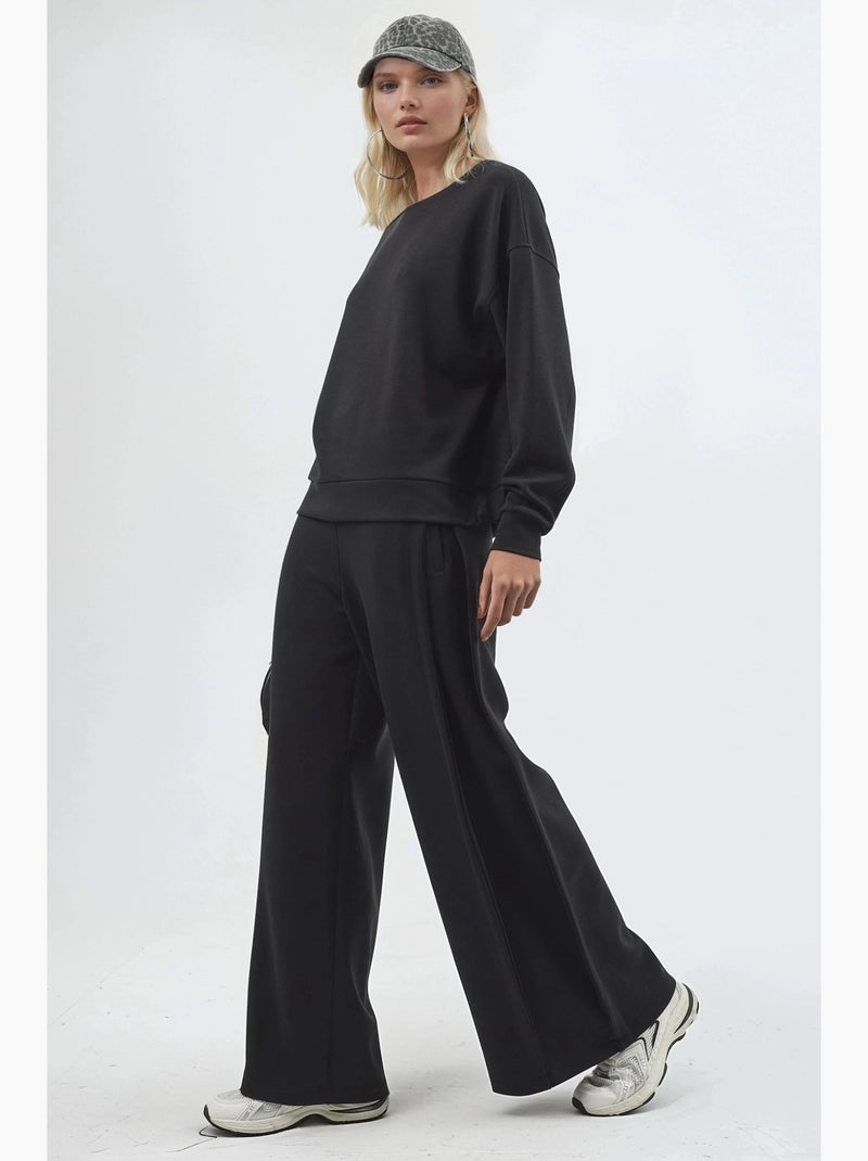 Pantaloni a gamba ampia con pieghe busem Nero - Kiabi