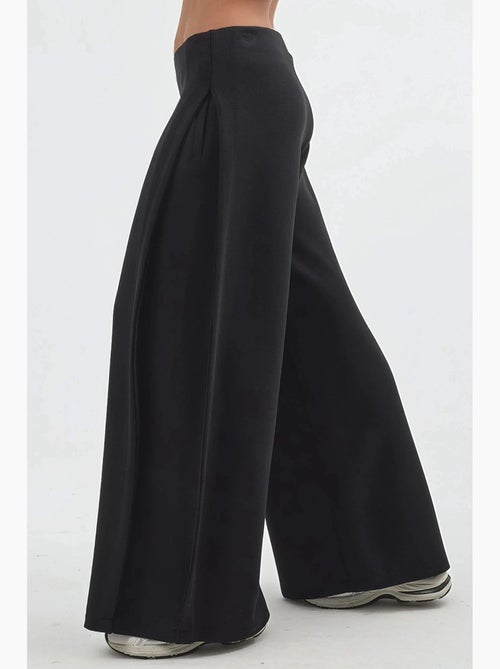 Pantaloni a gamba ampia con pieghe busem - Kiabi Pantaloni a gamba ampia con pieghe busem - Kiabi