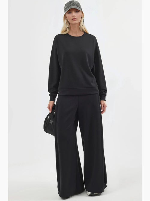 Pantaloni a gamba ampia con pieghe busem - Kiabi Pantaloni a gamba ampia con pieghe busem - Kiabi