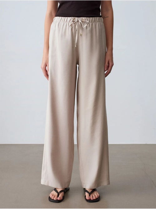Pantaloni a gamba ampia con vita elasticizzata e coulisse dilvin - Kiabi Pantaloni a gamba ampia con vita elasticizzata e coulisse dilvin - Kiabi