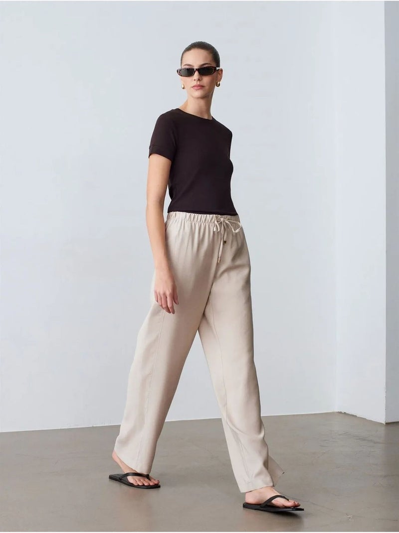 Pantaloni a gamba ampia con vita elasticizzata e coulisse dilvin Sabbia - Kiabi