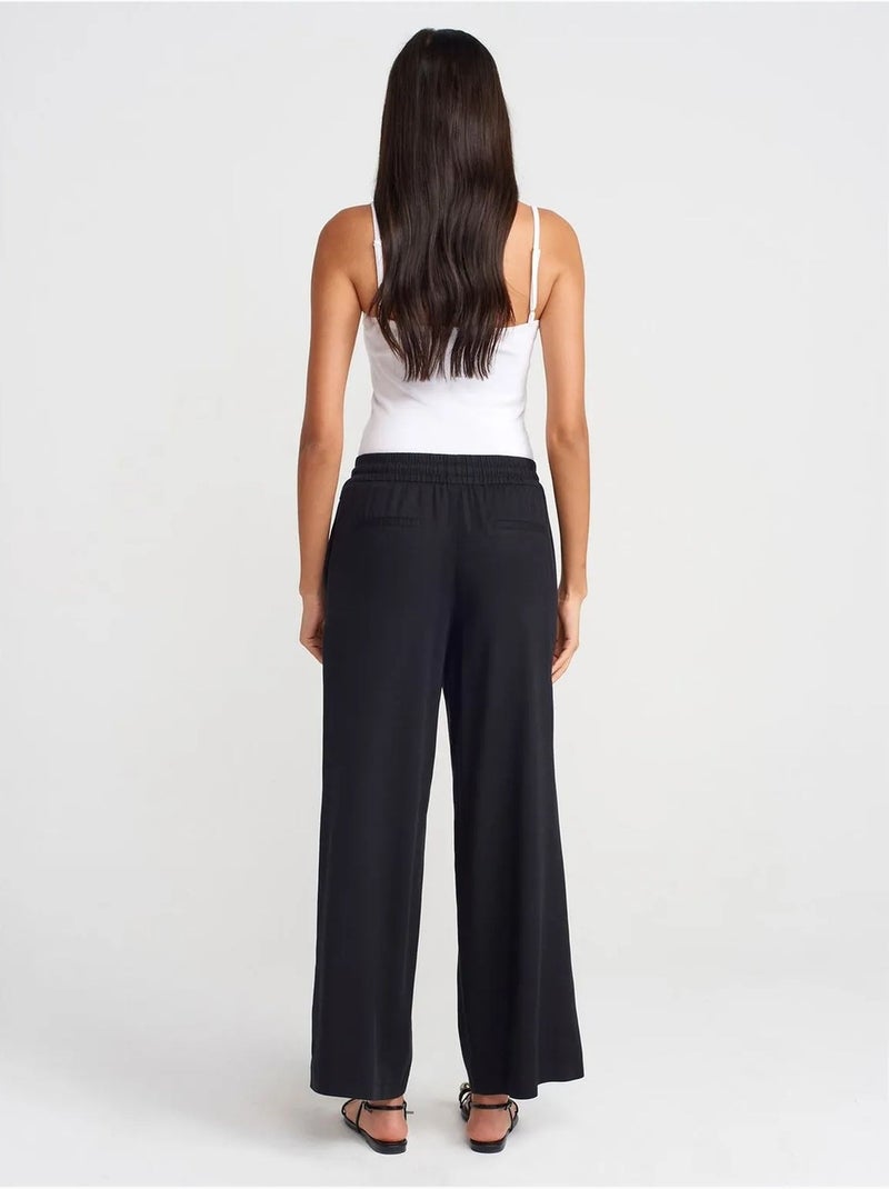 Pantaloni a gamba ampia in tencel con vita con coulisse dilvin Nero - Kiabi