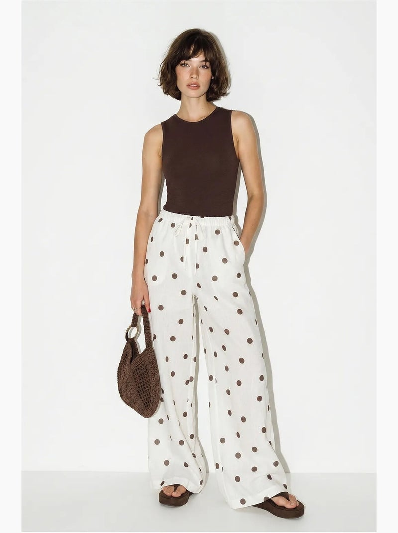 Pantaloni a pois a gamba ampia con cintura da annodare in vita lucci Ecru - Kiabi