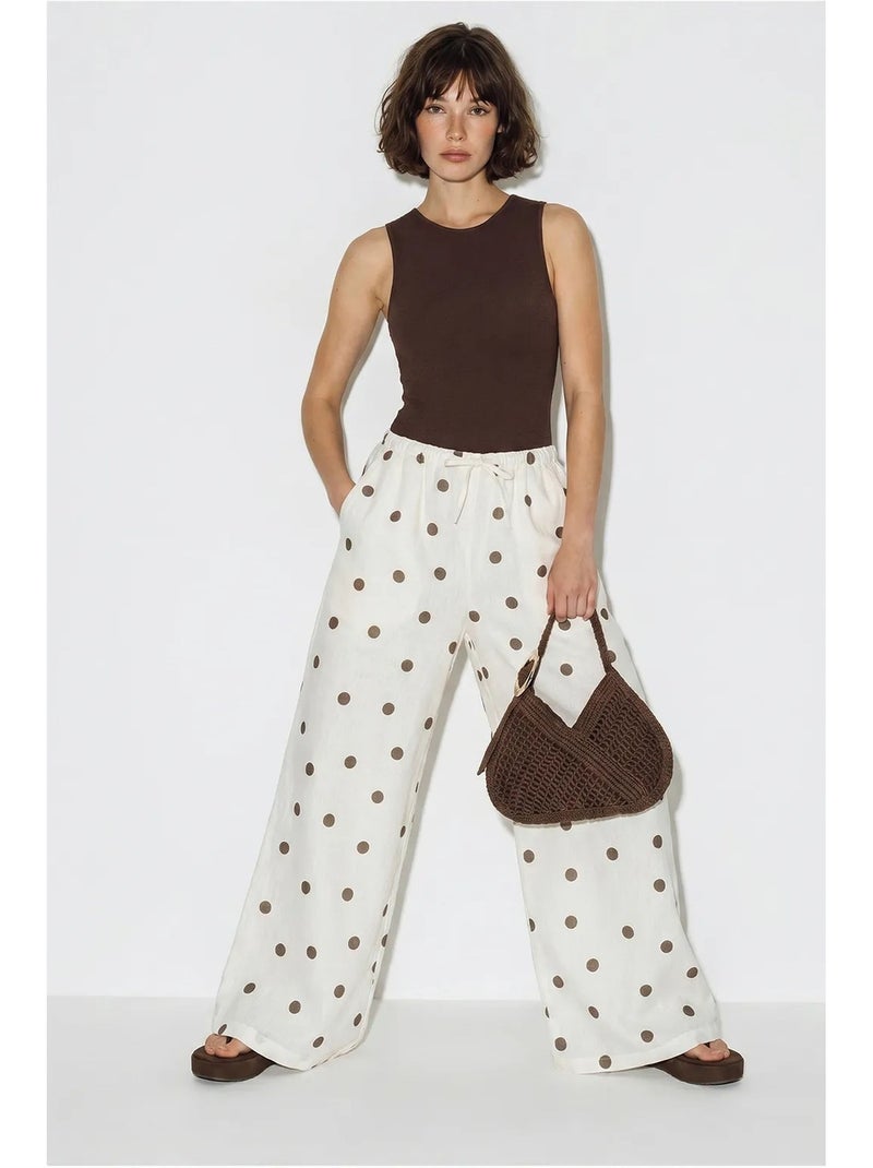 Pantaloni a pois a gamba ampia con cintura da annodare in vita lucci Ecru - Kiabi