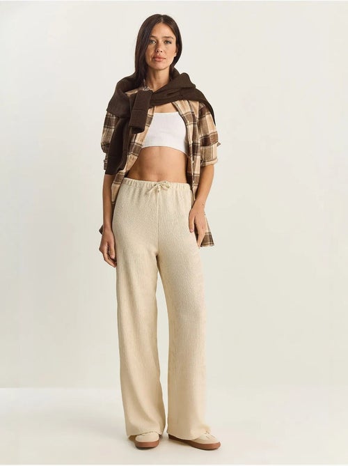 Pantaloni a vita alta a gamba ampia lucci - Kiabi Pantaloni a vita alta a gamba ampia lucci - Kiabi