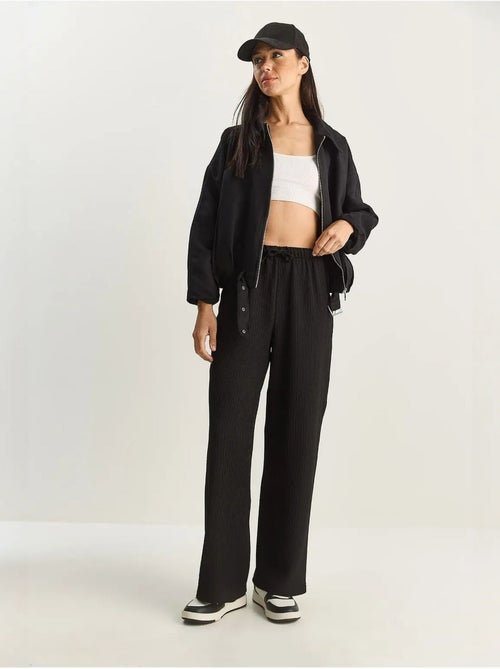Pantaloni a vita alta a gamba ampia lucci - Kiabi Pantaloni a vita alta a gamba ampia lucci - Kiabi