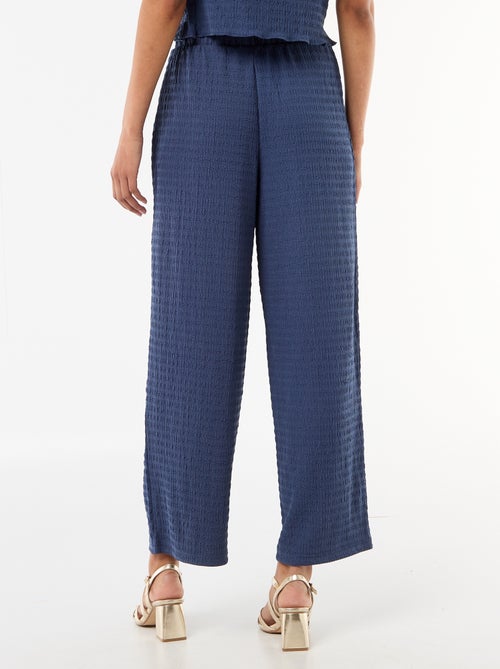 Pantaloni ampi in maglia smock - Kiabi