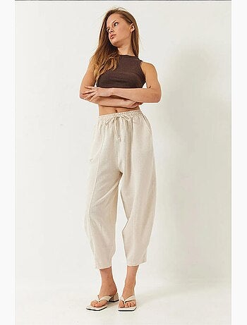 Pantaloni con elastico in vita e cavallo basso e dettaglio tasca lucci