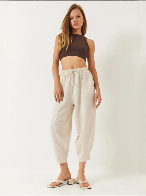 Pantaloni con elastico in vita e cavallo basso e dettaglio tasca lucci - Kiabi Pantaloni con elastico in vita e cavallo basso e dettaglio tasca lucci - Kiabi