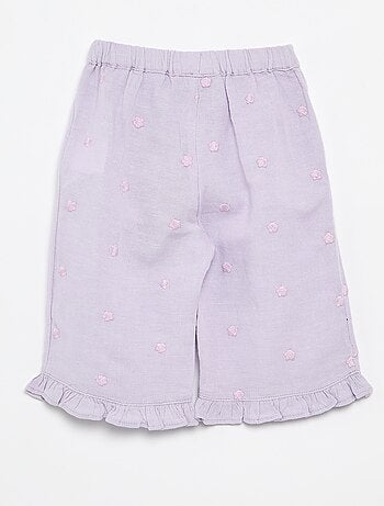 Pantaloni con ricami floreali