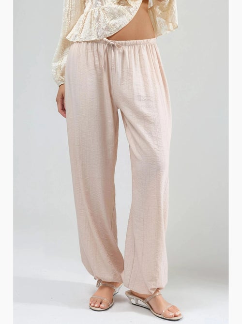 Pantaloni con vita elasticizzata e dettaglio con laccetto busem - Kiabi Pantaloni con vita elasticizzata e dettaglio con laccetto busem - Kiabi