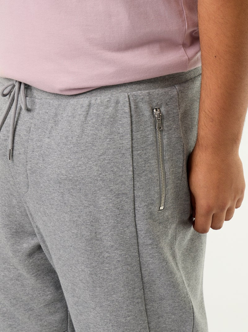 Pantaloni da jogging con fondo stretto e tasche con zip Grigio - Kiabi