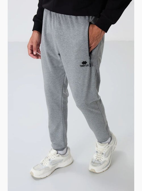 Pantaloni della tuta jogger da uomo con tasca con zip tommy - Kiabi Pantaloni della tuta jogger da uomo con tasca con zip tommy - Kiabi
