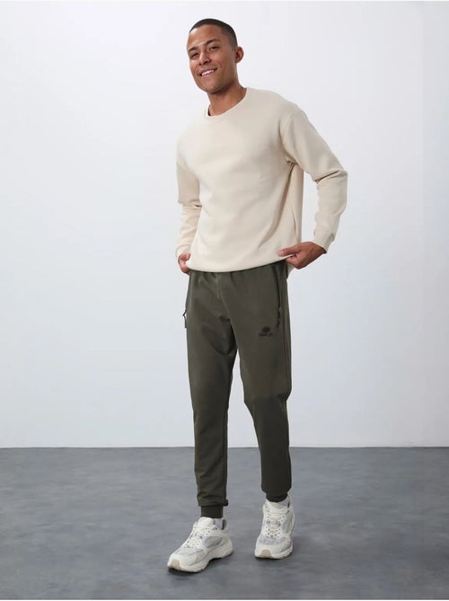 Pantaloni della tuta jogger da uomo con tasca con zip tommy - Kiabi Pantaloni della tuta jogger da uomo con tasca con zip tommy - Kiabi