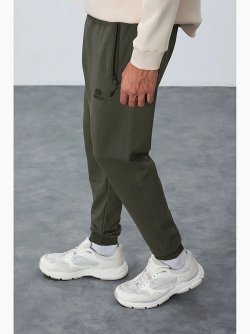 Pantaloni della tuta jogger da uomo con tasca con zip tommy - Kiabi Pantaloni della tuta jogger da uomo con tasca con zip tommy - Kiabi