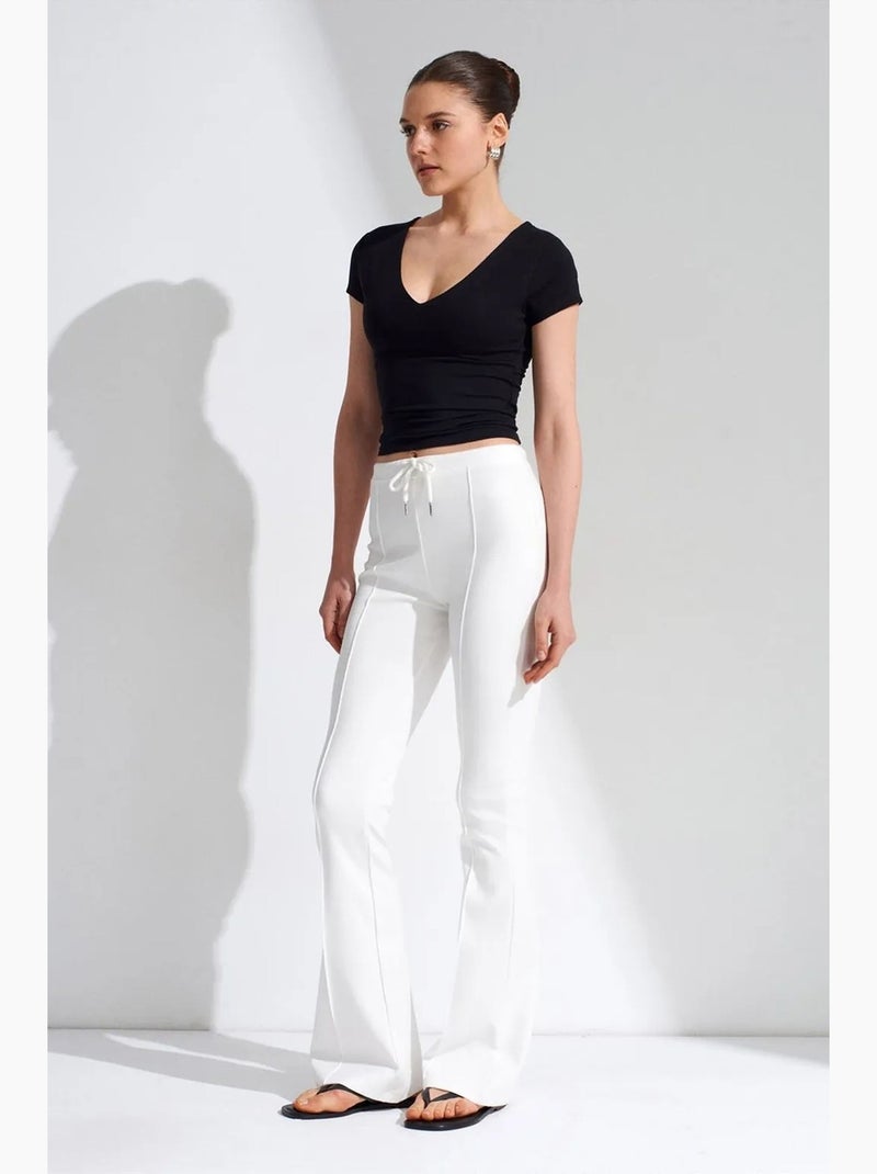 Pantaloni in jersey a zampa a vita media con coulisse dilvin Bianco - Kiabi