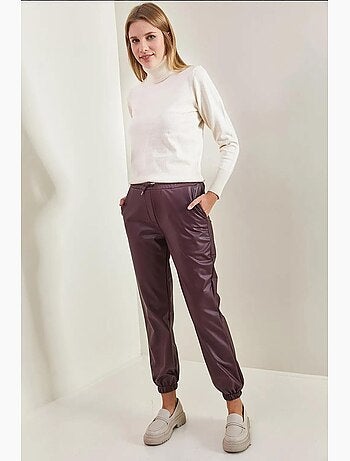 Pantaloni in pelle con elastico in vita e polsini lucci