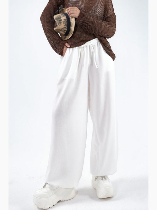 Pantaloni in tessuto a gamba larga con vita a coulisse busem - Kiabi Pantaloni in tessuto a gamba larga con vita a coulisse busem - Kiabi
