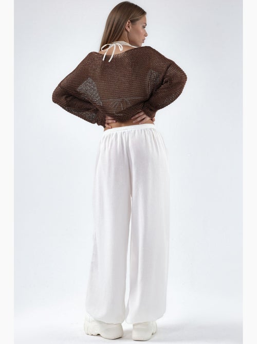 Pantaloni in tessuto a gamba larga con vita a coulisse busem - Kiabi Pantaloni in tessuto a gamba larga con vita a coulisse busem - Kiabi