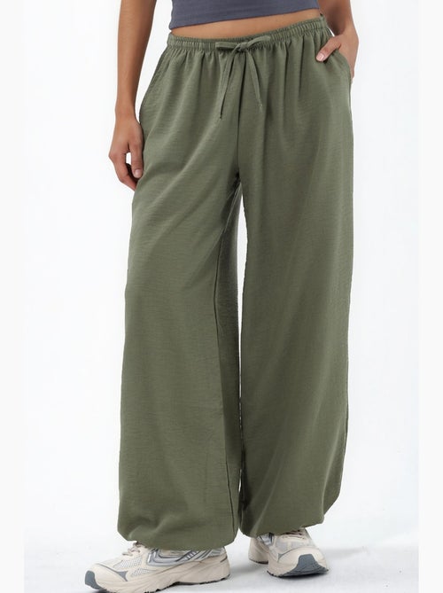 Pantaloni in tessuto a gamba larga con vita a coulisse busem - Kiabi Pantaloni in tessuto a gamba larga con vita a coulisse busem - Kiabi